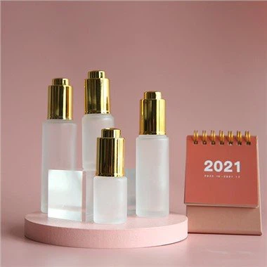 Vit droppflaska av glas